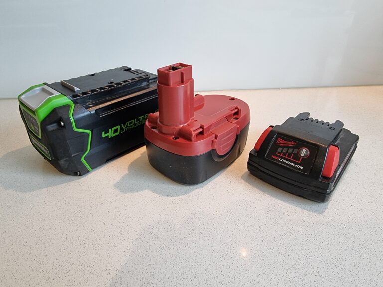 Three different types of batteries on a counter.