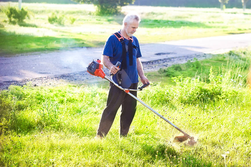 senior man with lawn mower