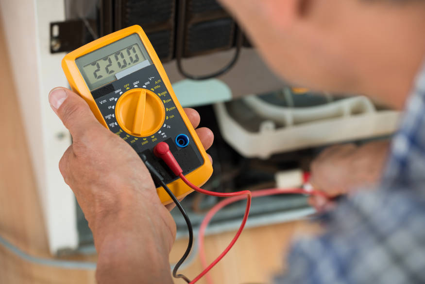 appliance repair man with multimeter