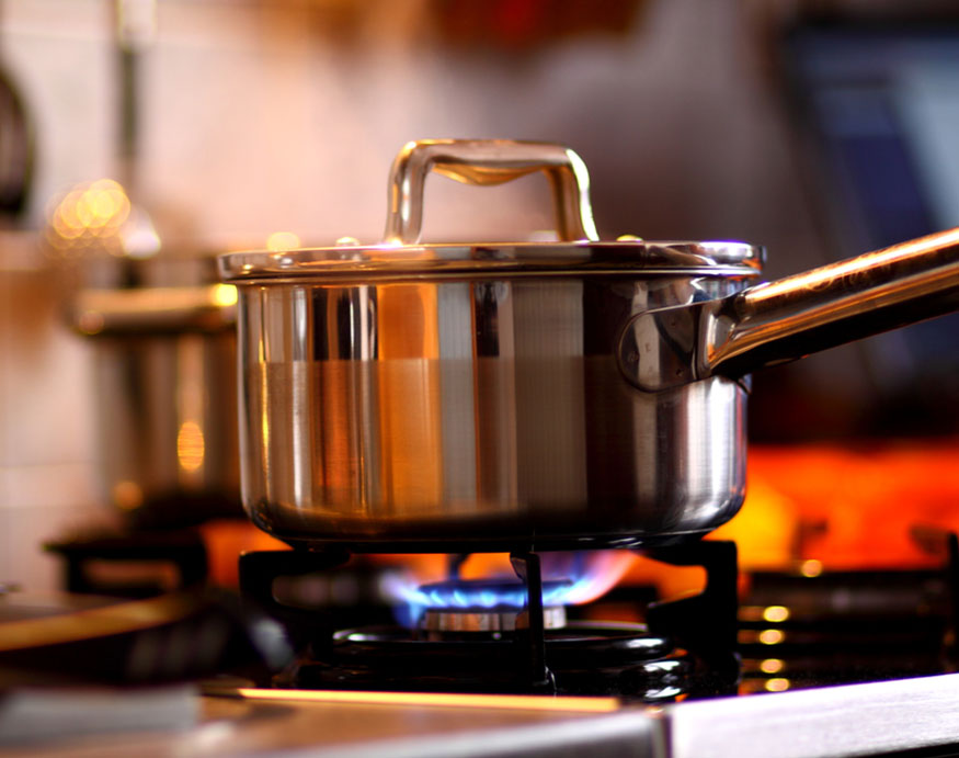 a stainless steel pot on a gas stove