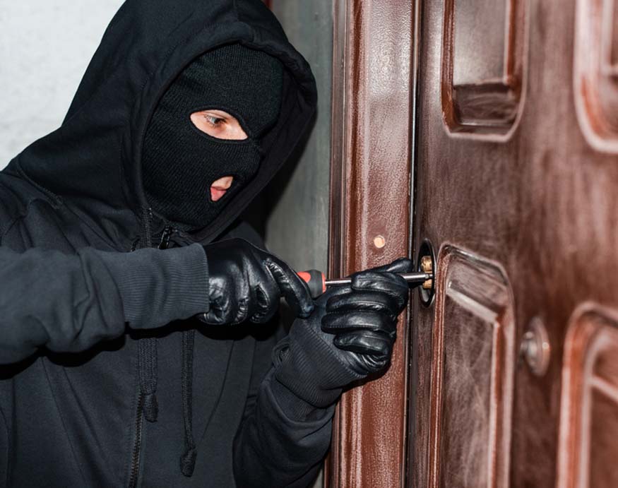 burglar trying to open a door lock