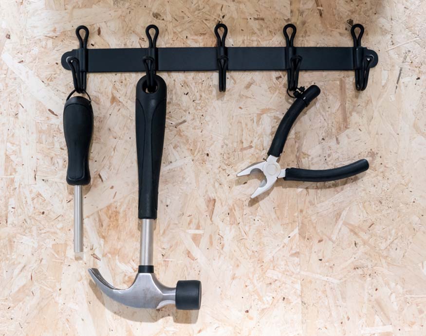 set of tools hanging from hooks