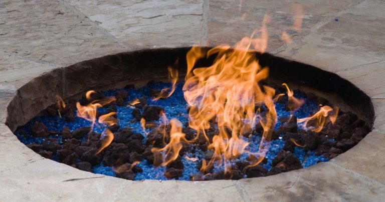 burning fire pit with fire glass and lava rock