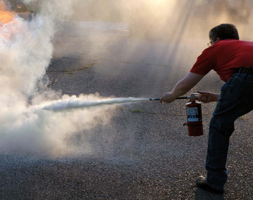 man using a fire extinguisher