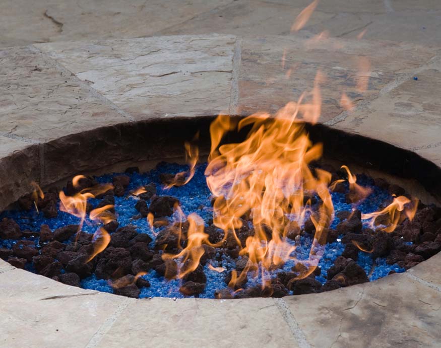 fire glass and lava rocks burning in the firepit