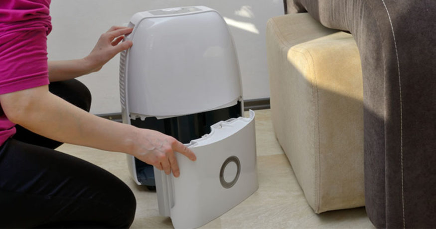 woman fixing a leaking dehumidifier