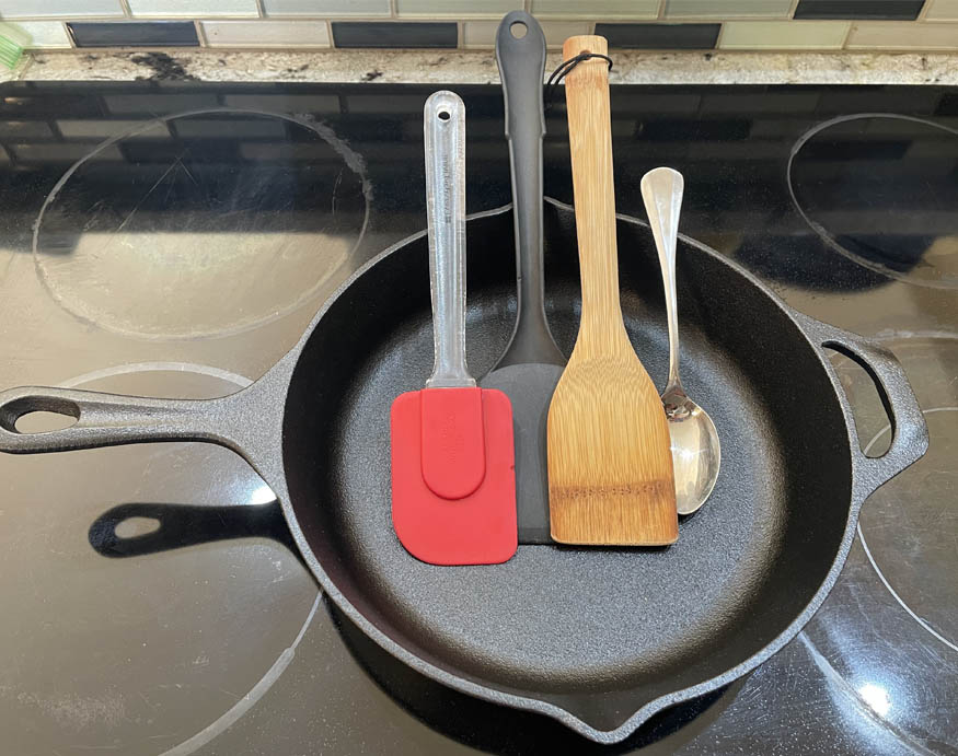 Different utensils on a cast iron pan. 
