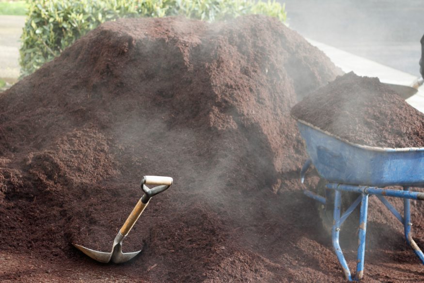 a hot compost pile with steam coming out