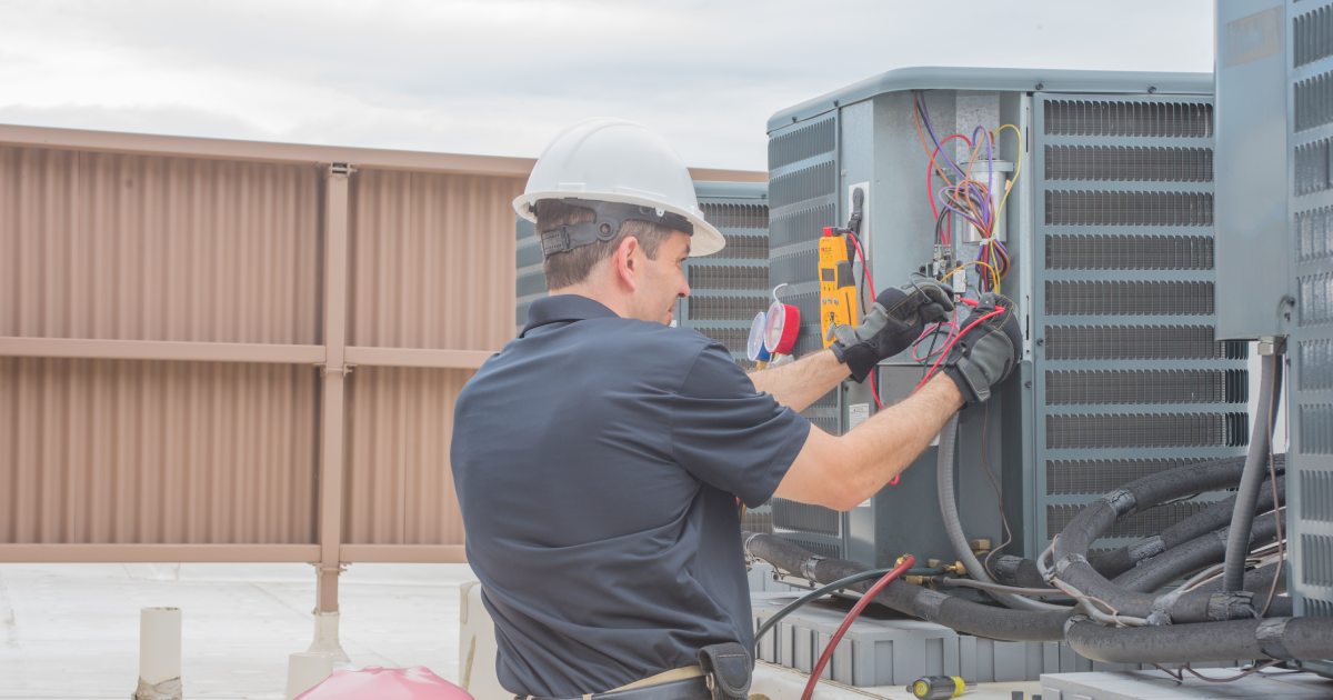 a HVAC technician checking the HVAC system