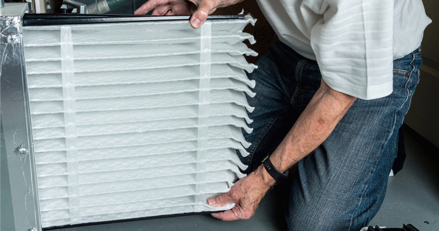 man changing a filter in a hvac system