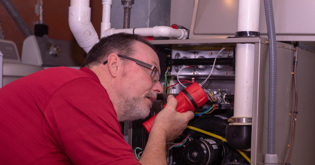 A HVAC technician inspecting the cause of furnace short cycling