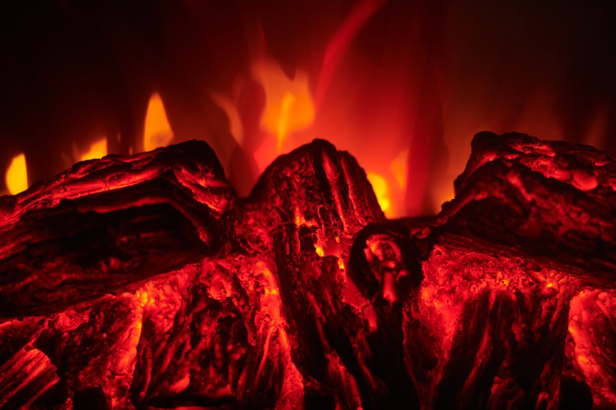 A close-up of a wall mounted electric fireplace’s flames