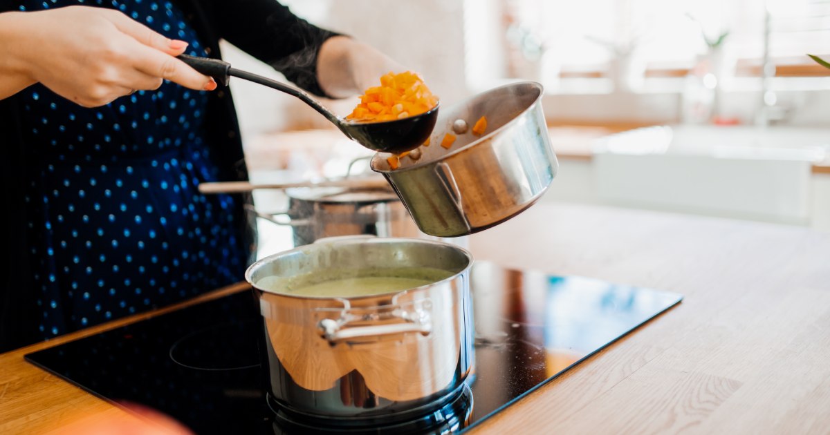 a person using the best pans for induction cooktop cooking
