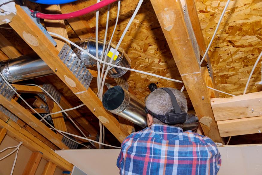 a house builder putting ductwork for HVAC