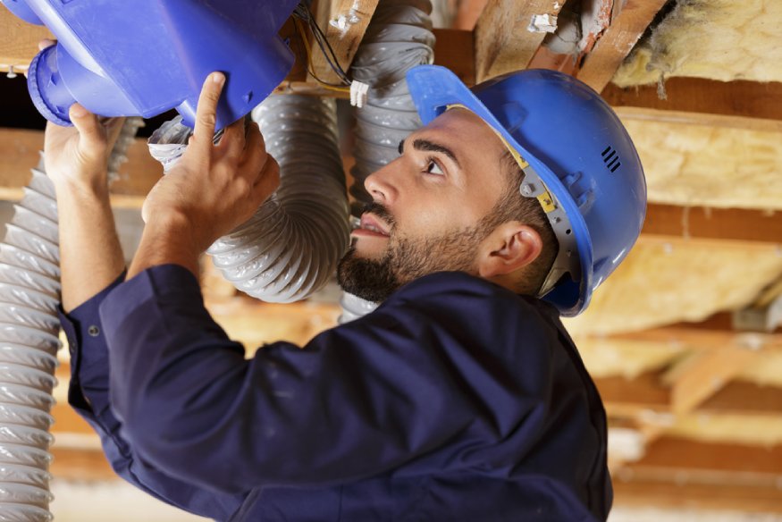 a worker installing ductwork