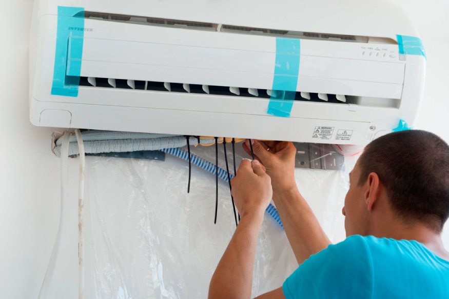 a technician installing the wires of a mini-split AC