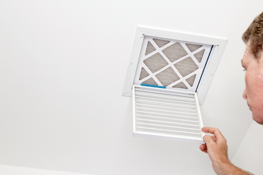 a person checking his home’s MERV air filter