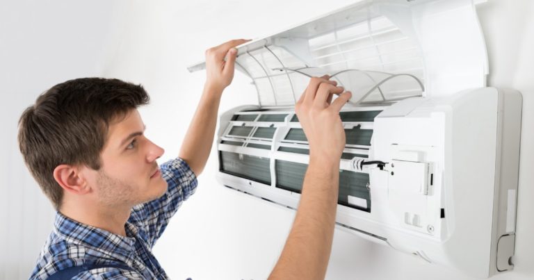 a technician inspecting a dual inverter air conditioner