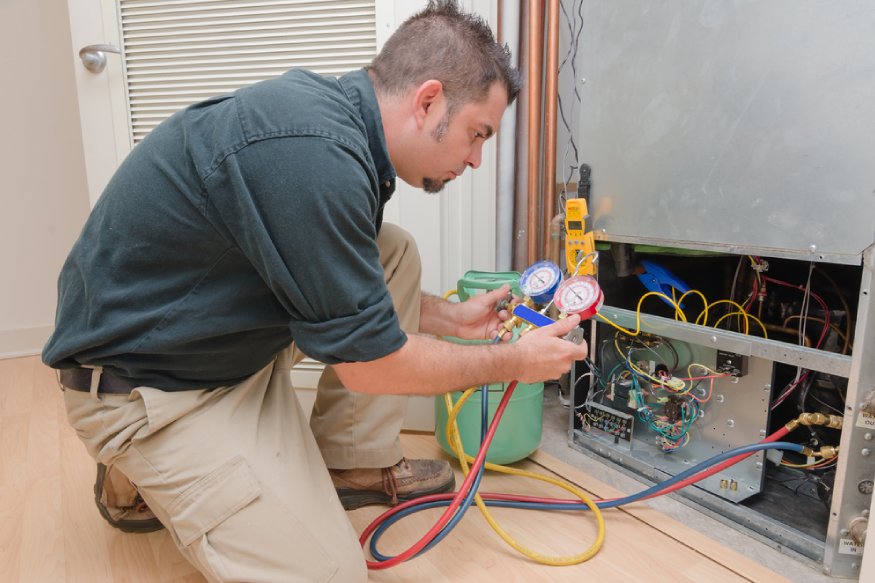 an HVAC technician looking for coolant leaks