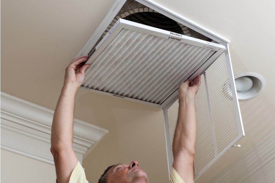 a person opening the return air vent
