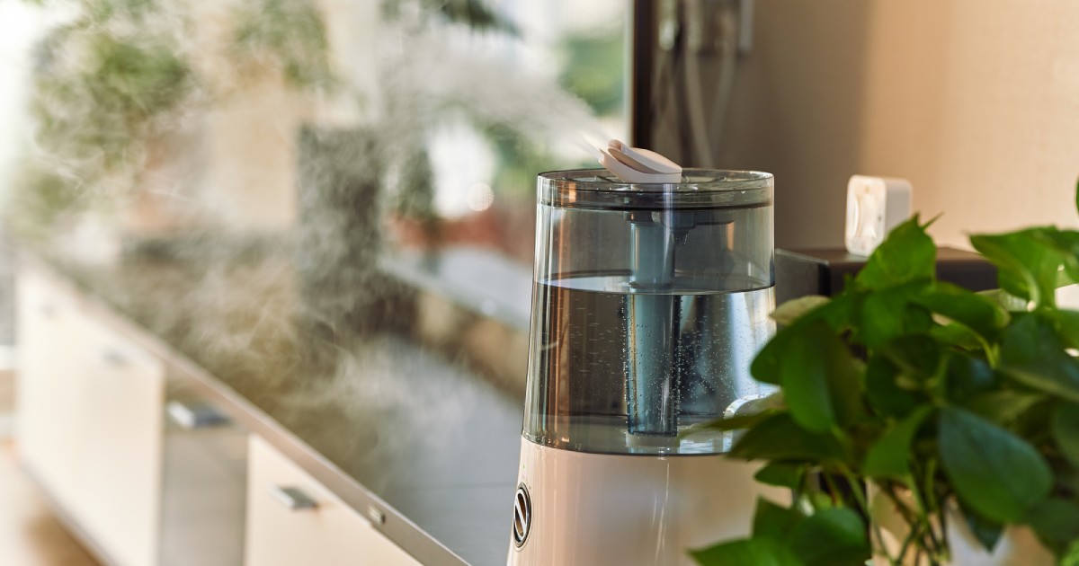 an ultrasonic humidifier releasing a cool, fine mist in the living room