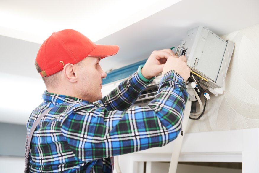 HVAC professional installing an AC