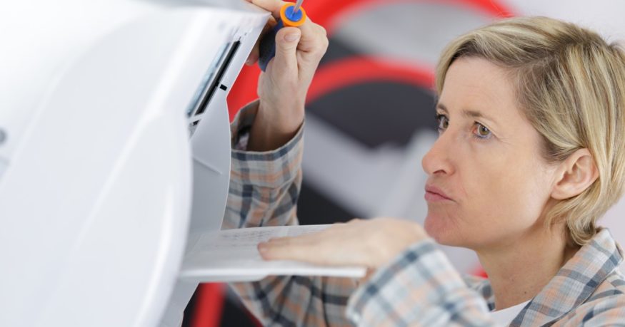 a woman checking why the dehumidifier is freezing up