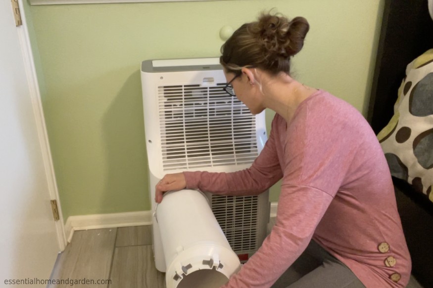 EHG writer, Sara Seitz, attaching the single hose system of a portable air conditioner