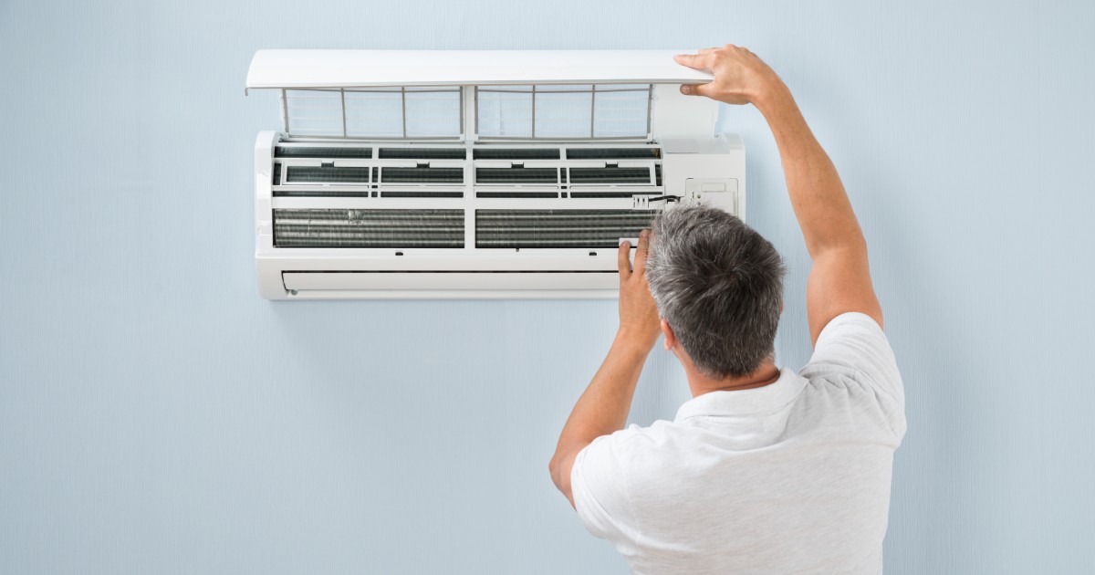 a man checking why his AC unit is freezing up