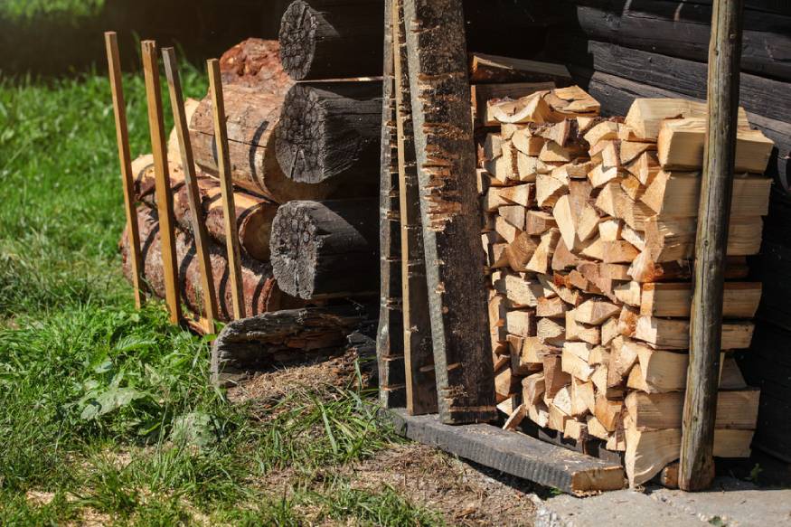 stack of firewood next to the wall