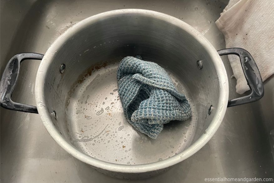 using a wet rag to clean a Legend Stainless Steel Copper Core pot