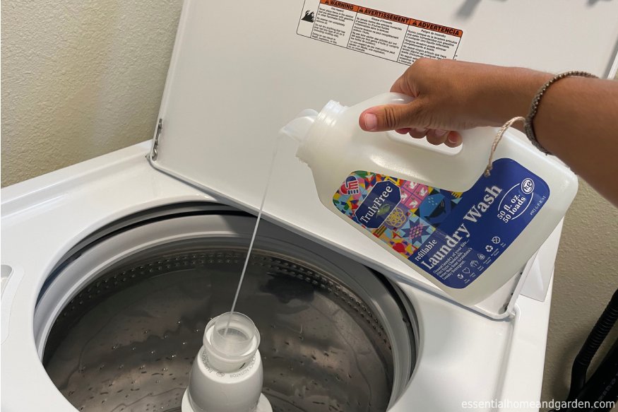 Pouring the Truly Free Home laundry detergent in the washing machine