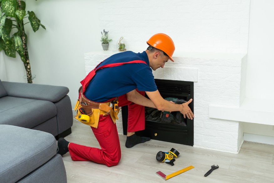 a technician installing an electric fireplace