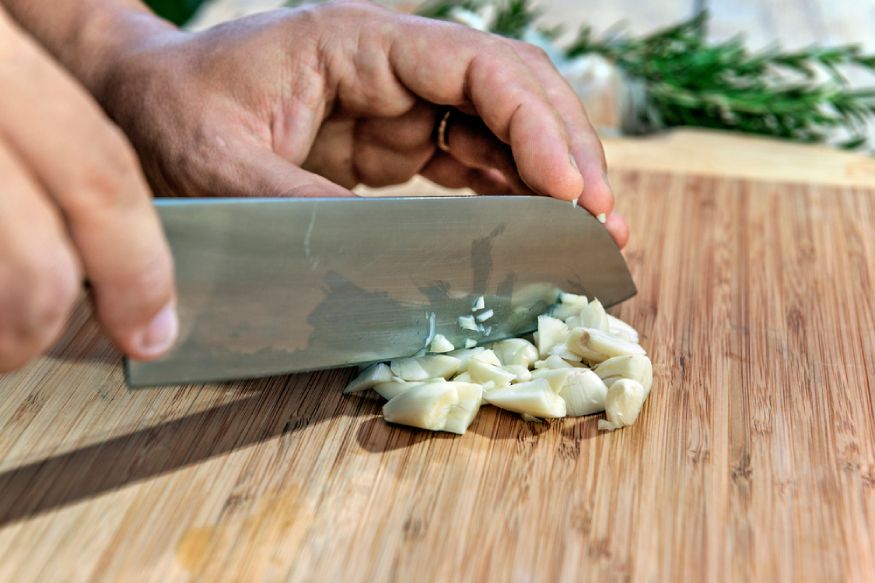 a person chopping garlic