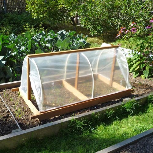 Picture of a hoop house complete with a shade cloth.