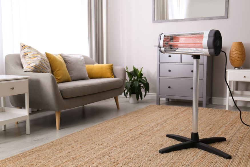 A heater sitting on a stand in a living room.