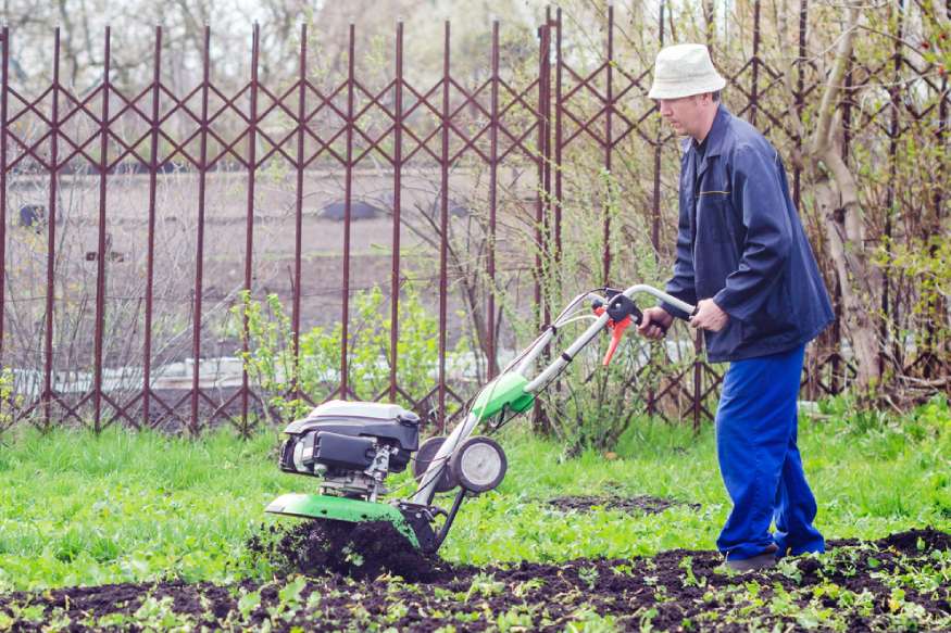 a gardener using a cultivator