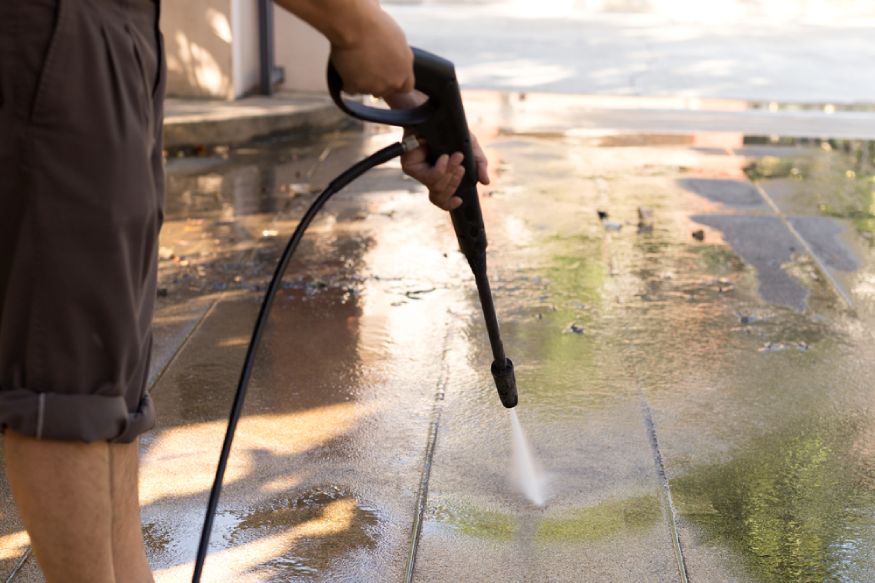 man adjusting the pressure setting of a water pressure