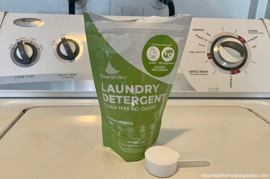 EnviroKlenz Laundry Detergent Powder with scoop on washer