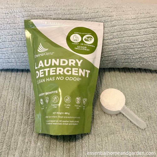 EnviroKlenz Laundry Detergent Powder with scoop on a towel