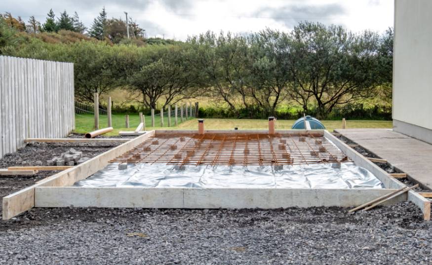 photo showing concrete foundation for greenhouse