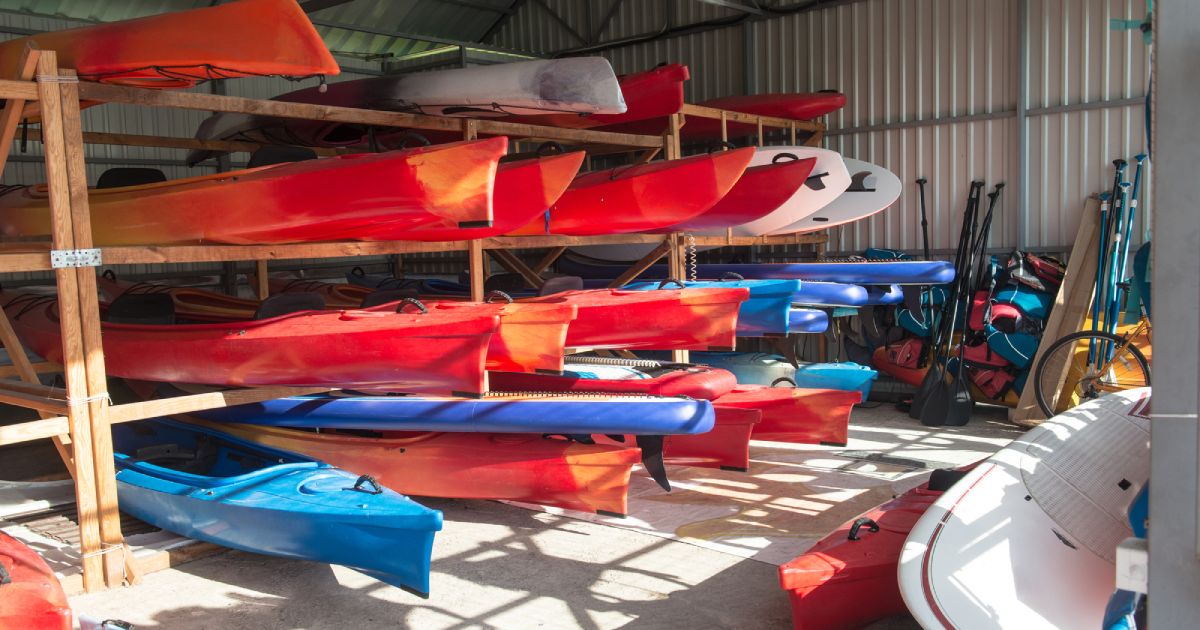rows of kayaks stored in the garage