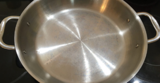 a stainless steel pan with white spots on it