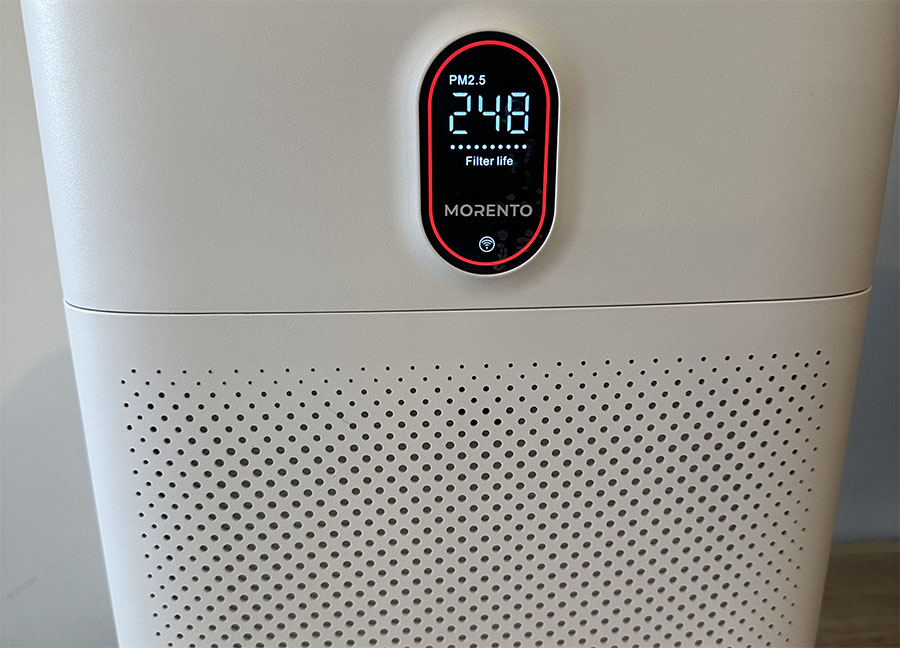 Close-up view of a morento air purifier showing a digital display with pm2.5 reading at 24.8 and filter life indicator.