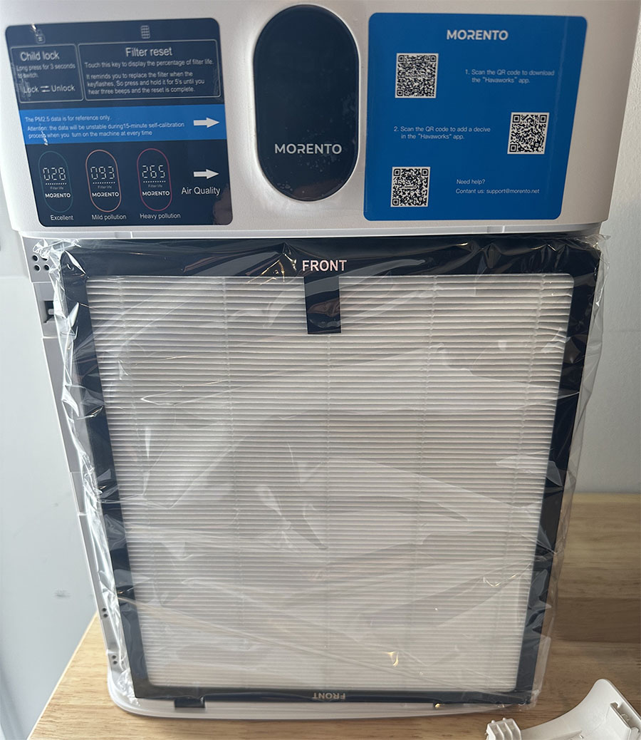 A new morento air purifier in its packaging, displayed on a showroom shelf with informational qr codes and digital screen showing settings above.