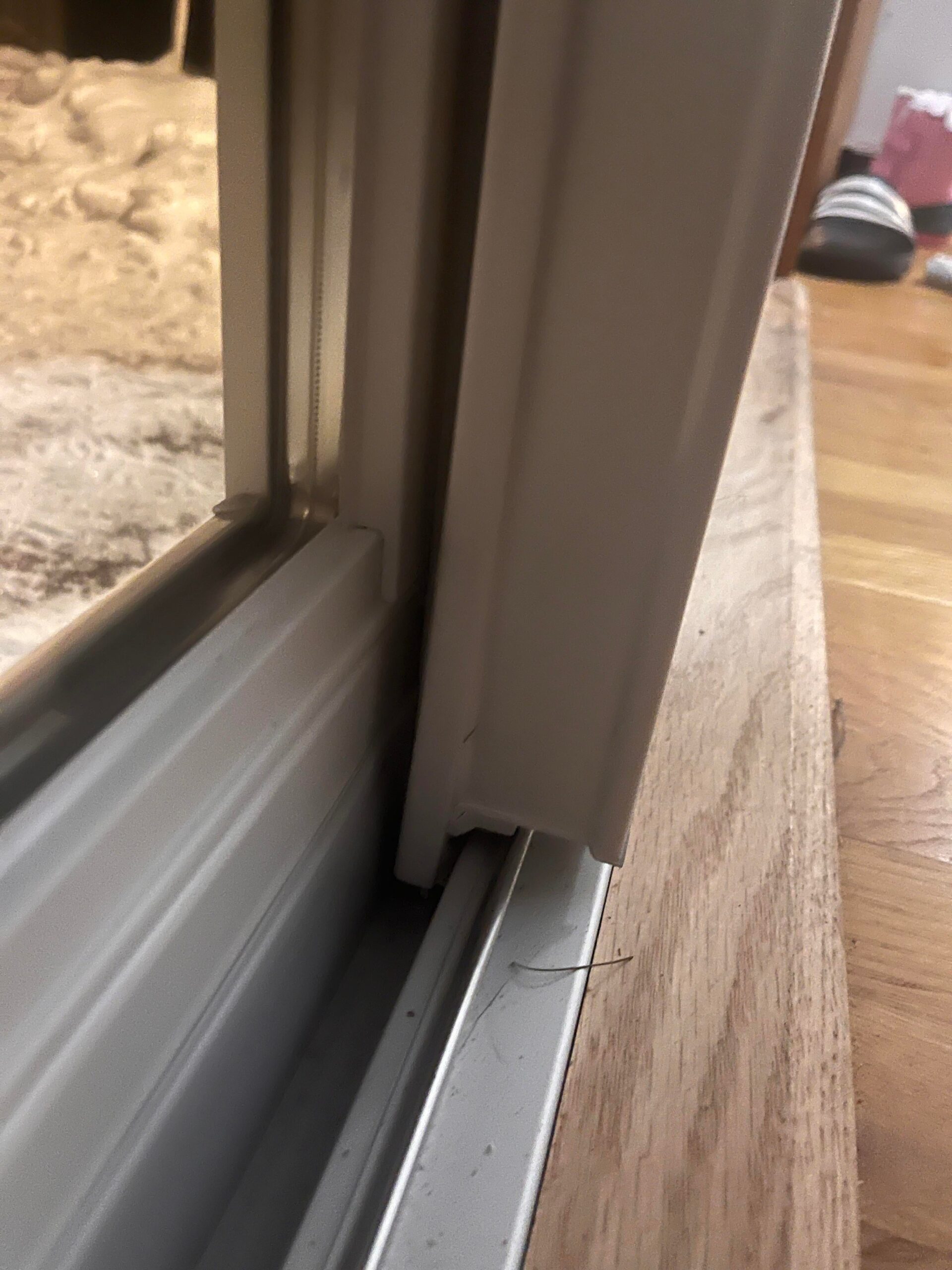 Daylight showing through the gap at the bottom of a sliding door